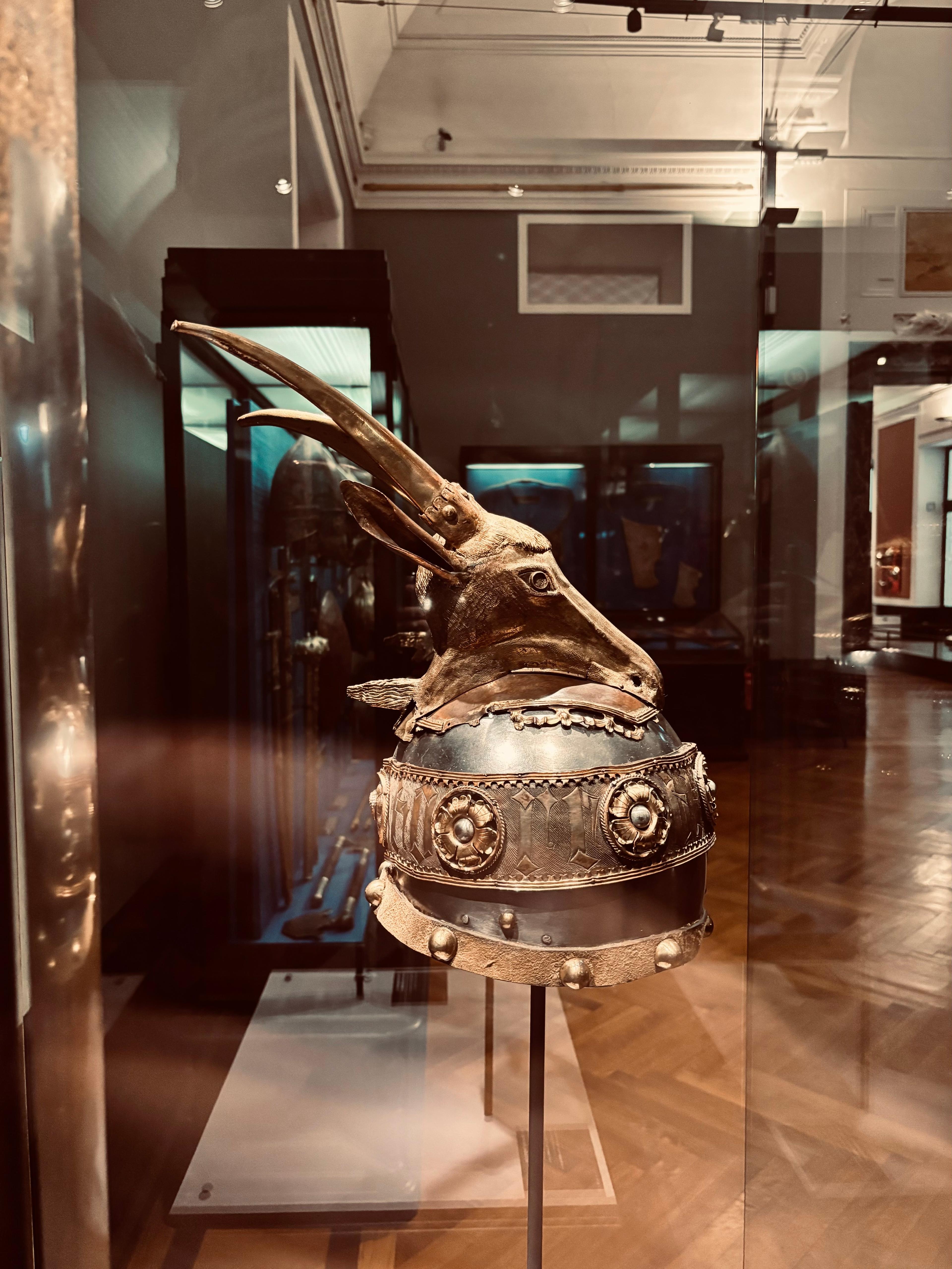 Medieval ceremonial helmet on display in a museum