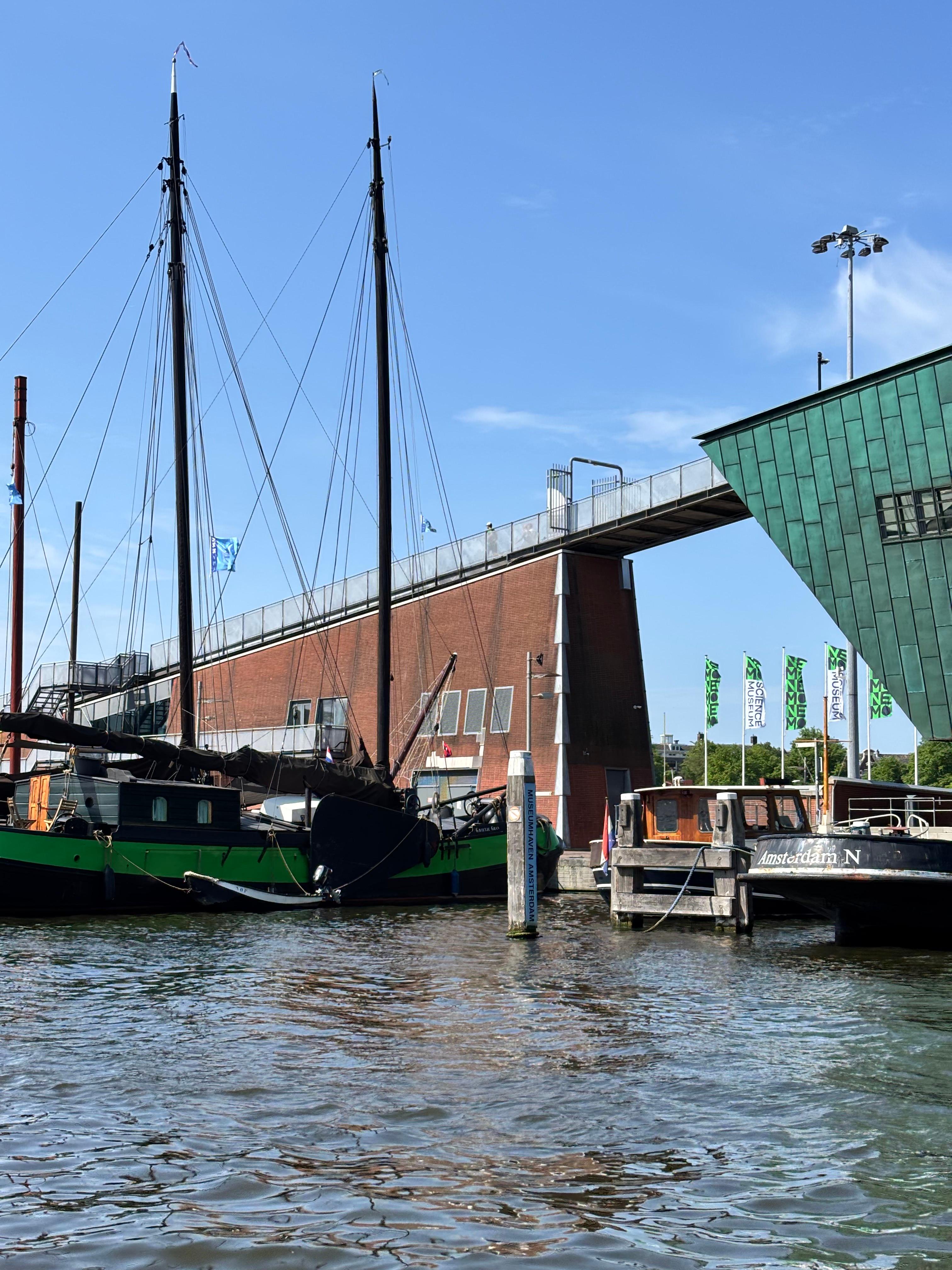 Old tall ship masts moored by the Amsterdam waterfront