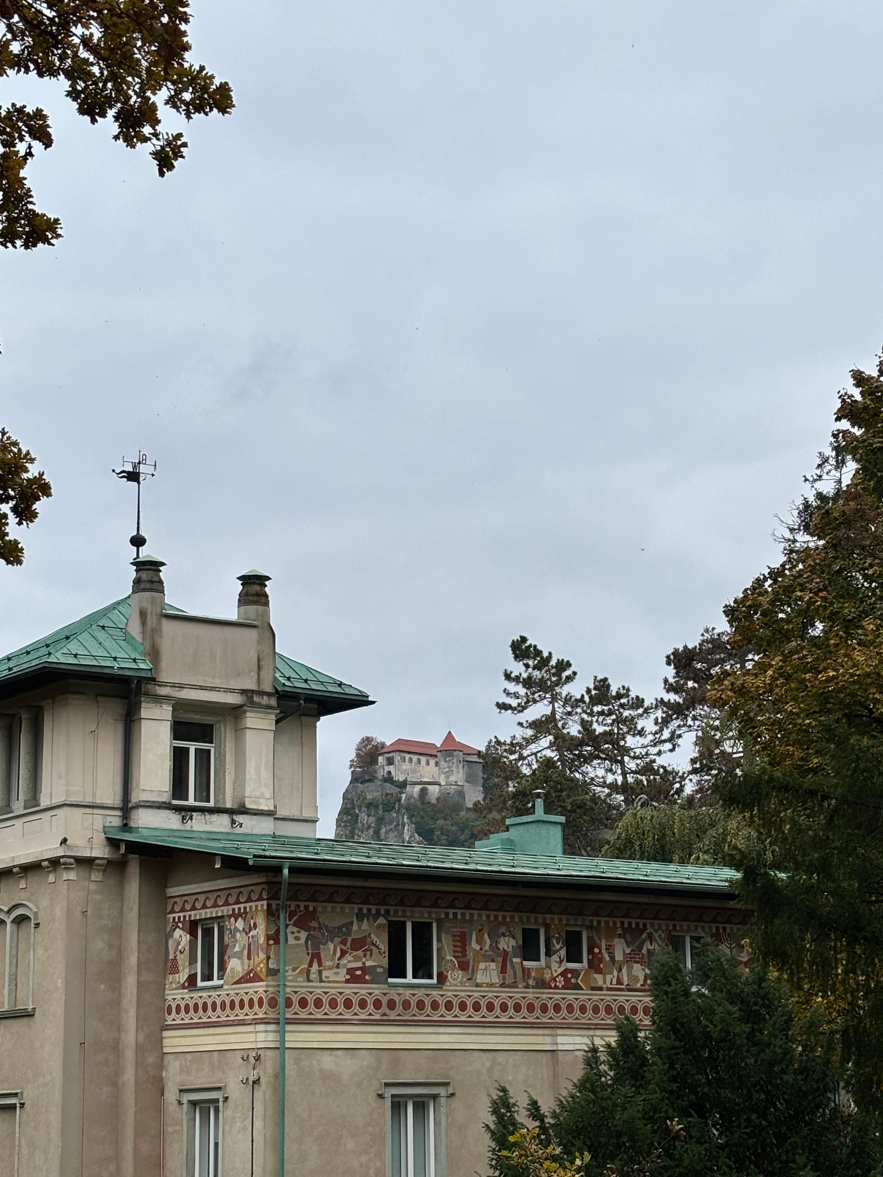 Building with painted frescoes and green copper roof