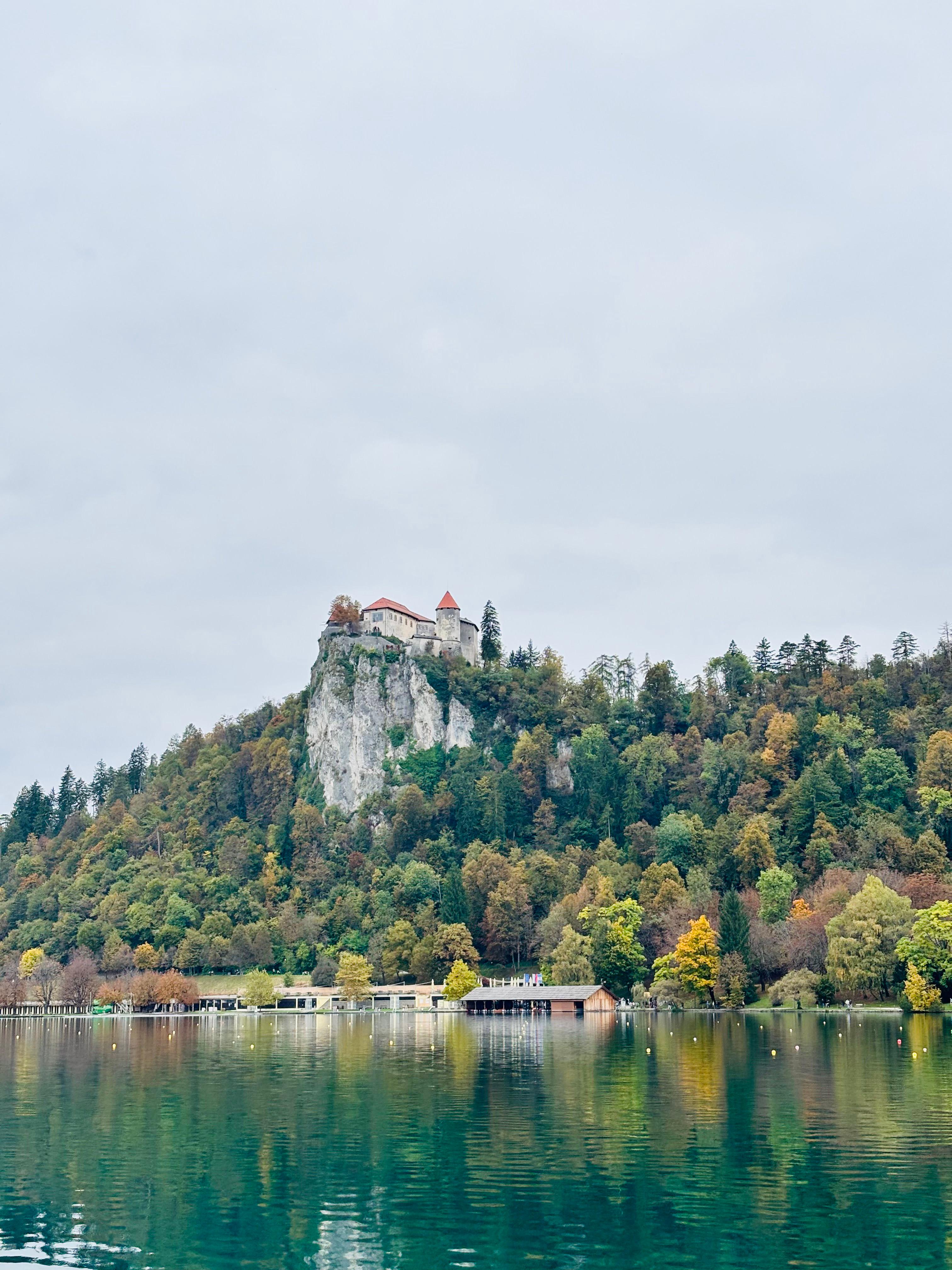 Bled Castle perched on a cliff above Lake Bled in autumn